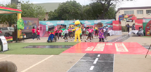 Some of the children joined by the five characters in a dance