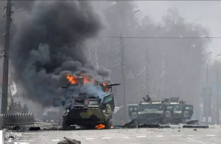 February 27, 2022: A Russian armoured personnel carrier burns next to body of an unidentified soldier.