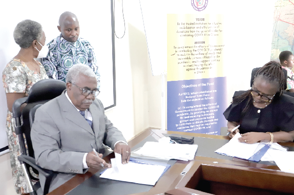 Dr William Collins Asare (left), Administrator, COVID-19 National Trust Fund, and Prof. Dorothy Yeboah-Manu, Director, Noguchi Memorial Institute for Medical Research, signing the agreement in Accra. Picture: Samuel Tei Adano