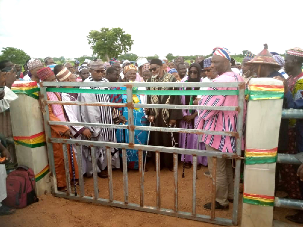 Issahaku Aremeyaw Somo (right), the MCE for Walewale, being assisted by leadership of the Fulani Herdsmen to inaugurate the facility 