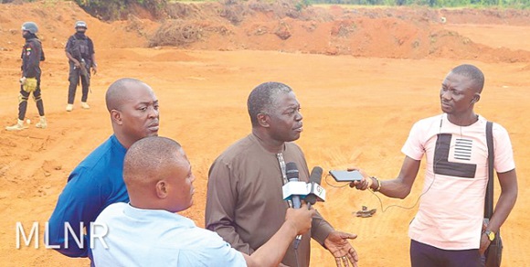 Benito Owusu-Bio, Deputy Minister of Lands and Natural Resources in charge of Lands and Forestry, speaking with some journalists on the illegal sand-winning activities on state lands at Amrahia in the Adentan municipality in the Greater Accra Region