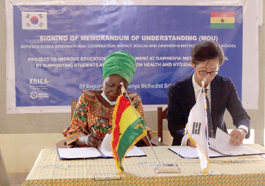 Heon Kong and Regina Amegah exchanging the agreement after signing. Picture: DELLA RUSSEL OCLOO