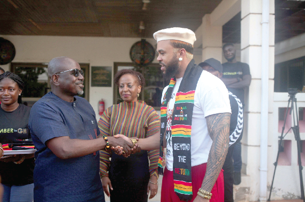 Jidenna Theodore Mobisson (right), American Rapper and Singer, exchanging pleasantries with Akwasi Agyeman (left), CEO of the Ghana Tourism Authority, during the arrival of the delegation from Birthright Africa. With them is Walla Elsheik (middle), CEO and Co-Founder of Birthright Africa. Picture: Maxwell Ocloo
