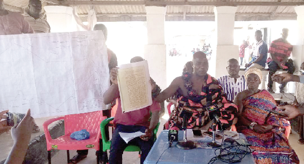 Nana Kwesi Mensah III (middle), the Chief of Kwaprow, explaining a point to journalists at the press conference