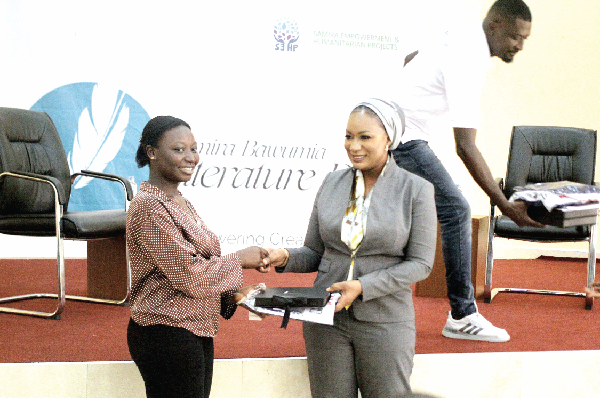 Samira Bawumia (right), wife of the Vice-President,  presenting a gift to Mary Bomaba, Business Administration student of the University of Ghana, at the event Picture: Maxwell Ocloo