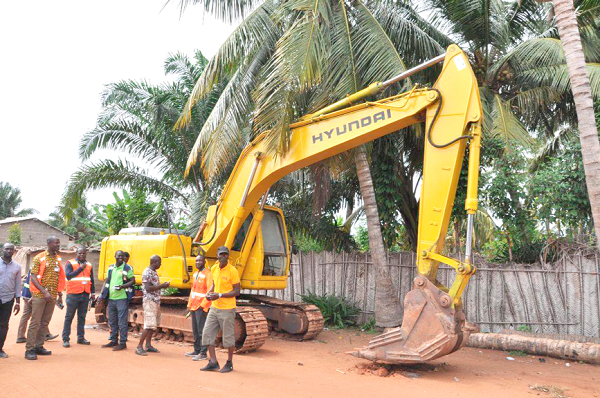 Some local residents and officials of EPA by an abandoned excavator