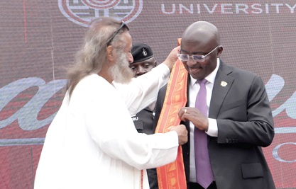 Vice-President Dr Mahamudu Bawumia  (right), being decorated with a sash by Gurudev Sri Sri Ravi Shankar (left), Global Peace Ambassador. 