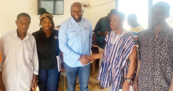Prince Sefah (3rd from left), Chief Executive Officer of GIFEC, exchanging pleasantries with Nana Owusu Mireku, a traditonal representative of the Onyemso community. With them are staff of GIFEC and members of the community