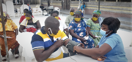 A health worker checking the blood pressure of a beneficiary of the exercise