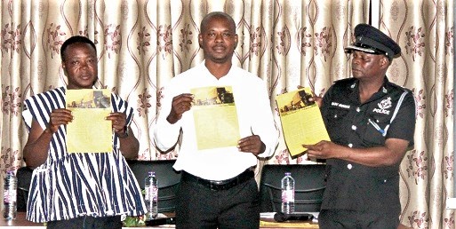 Chief Superintendent Dr Samuel Sasu-Mensah (right), Director of Operations, MTTD, with Dr Charles Nyaaba (left), Executive Director, Peasant Farmers Association of Ghana, and Awal Wepia Addo (middle), President of PFAG, launching the flyer for road users. Picture: Maxwell Ocloo