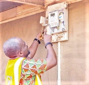 A technical officer of the ECG disconnecting one of the meters at the Best Crystal Hostel facility 