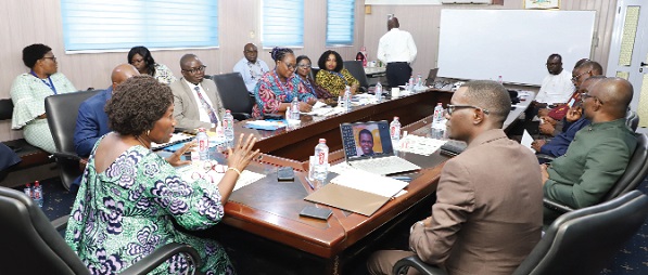 Doris Addae-Afoakwa (hand raised), Chairperson of the Pharmacy Council, introducing Dr Jean Damascene (right), Registrar of the Rwanda National Pharmacy Council, during a visit to the Pharmacy Council in Accra. Those in the picture are senior staff of the Pharmacy Council, Ghana. Picture: GABRIEL AHIABOR