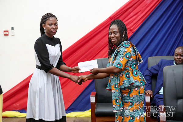 Prof Sarah Darkwa presenting one of the awardees with her research grant