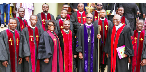 Rt. Rev. Dr  Dogbe, Presiding Bishop of the Western West Africa Episcopal District of the AME Zion Church (holding a staff) with other members of the clergy 