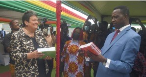 Dr Yaw Adutwum (right), Minister of Education, examining one of the books presented to him by Virginia E. Palmer, the US Ambassador to Ghana