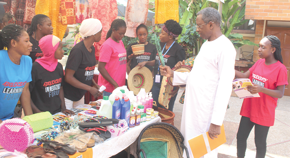 Barnabas Yisa (2nd from right), Country Representative of the United Nations Population Fund, inspecting some of the items made by the girls during the ceremony. With him is Abigail Edem Hunu (3rd from right), Programme Assistant for Gender at UNFPA. Picture:   ESTHER ADJORKOR ADJEI