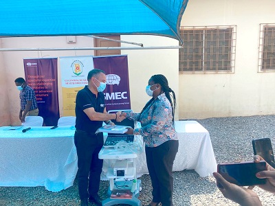 Jose Fernandes, West African Manager of SMEC (left) handing over documents to the machine to Dr Esther Odame-Asiedu, Ga Central Municipal Director of Health.