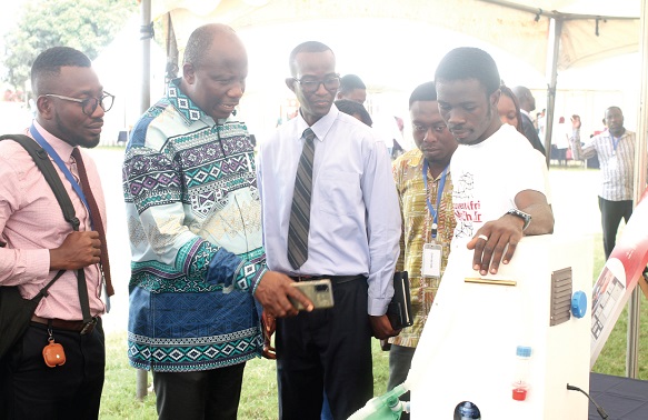 Dr Robert Djagbletey (3rd from left), Head, Department of Anesthesia, University of Ghana Medical School, and Dr Nicholas Adjabu (2nd from left), Head, Biomedical Engineering Unit, Ministry of Health, looking at one of the ventilators on display at the fair. PICTURE: MAXWELL OCLOO
