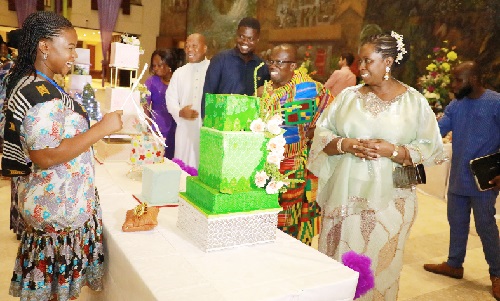 Efua Otua Goode Obeng Kyei (right), Director of the EKGS Culinary Institute, leading other guests to inspect the products of one of the graduands