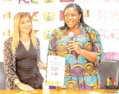 Kathleen Addy (right), Chairperson of the NCCE, and Anna Lixi, Head of Security and Governance of the EU Delegation to Ghana,  displaying the signed PCVE agreement