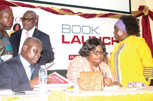 Justice Prof. Henrietta Mensa-Bonsu (2nd from right), Justice of the Supreme Court, signing copies of the book at the launch. With her is Chief Justice Kwasi Anin Yeboah (left). Others are Prof. Audrey Gadzekpo (right) and Justice Prof. Nii Ashie Kotey (behind), Justice of the Supreme Court. Picture: MAXWELL OCLOO