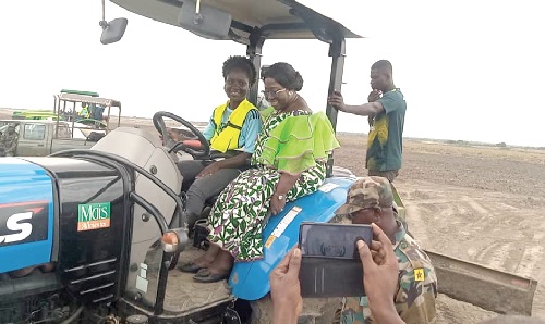 Akosua Frema Osei-Opare, Chief of Staff, being offered a ride on a tractor after the launch