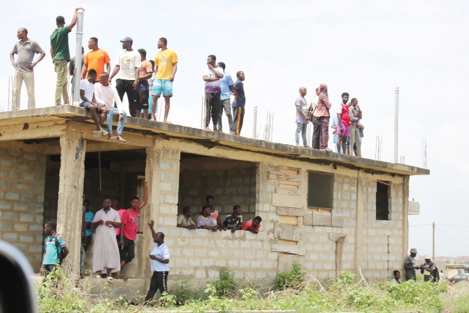 Some observers at the scene of the demolition exercise. Picture: Della Russel Ocloo
