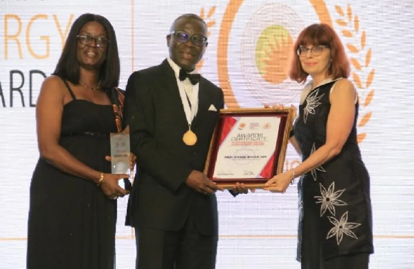  Prof. Kwaku Appiah-Adu (middle), Senior Policy Advisor at the Vice-President’s Secretariat, Office of the President,  receiving the award