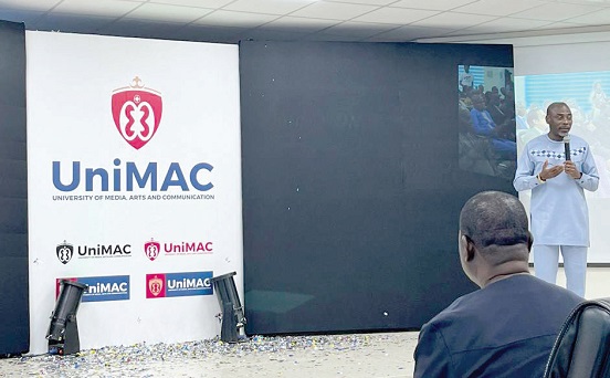 Prof. Kwamena Kwansah-Aidoo (standing), acting Vice-Chancellor of the UniMAC, addressing the gathering after unveiling the logo