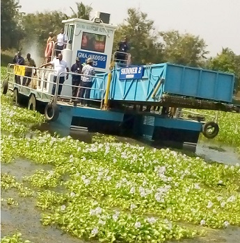 One of the skimmer boats clearing weeds from the lake at Kpong 
