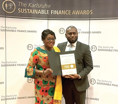 Gina Blay (left), Ghana’s Ambassador to Germany, and John Akuoko-Tawiah, Head, Sustainability and Climate Finance at DBG, displaying the award