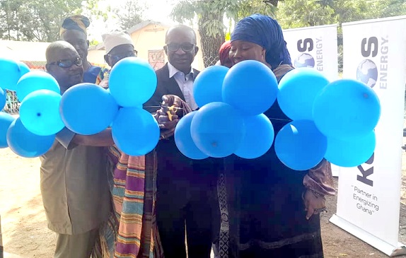 Ayishetu Seidu (right), Municipal Chief Executive for Savelugu, being assisted by Appiah Kyei (middle), Director of New Ventures at Kosmos Energy, and officials of the school to cut the ribbon