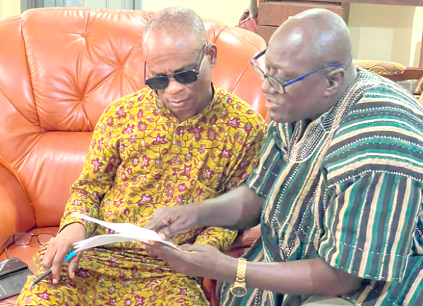 Colonel Kwadwo Damoah (retd) [right] taking Kwame Asare Boadu, a Deputy News Editor of the Daily Graphic, through some documents