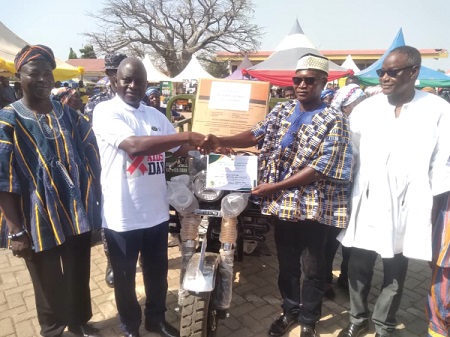 Stephen Yakubu (2nd from left), the Upper East Regional Minister, presenting the Regional Best Farmer award to Awintuna Akande (2nd from right) during the ceremony. Looking on are Rex Asanga (right), the MCE for Bolgatanga, and Alhaji Zakaria Fuseini (left), the Regional Director of the Department of Agriculture