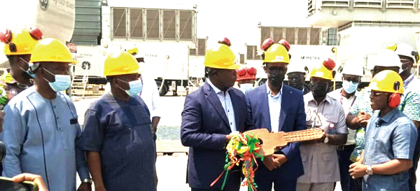 Mr Francis Kofi Kpolu, (4th from right), the Country Manager of AMERI Energy, handing over the keys to Mr William Owireku Aidoo (right), Deputy Minister of Energy, while Mr Kwabena Okyere Darko Mensah, the Western Regional Minister looks on