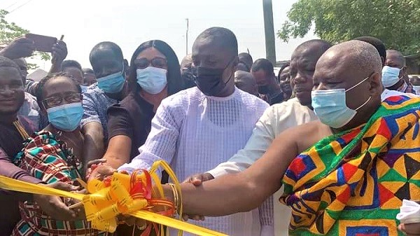 Mr Afenyo-Markin (middle) being assisted by other guests to inaugurate the health centre. 