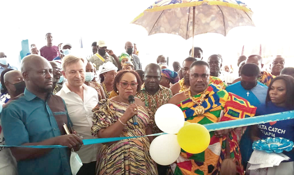 Mrs Mavis Hawa Koomson (3rd from left), Minister of Fisheries and Aquaculture, being assisted by Nii Kwashie Gborlor, the Chief of Ngleshie Amanfro, to inaugurate the Volta Catch Tilapia Depot. With them are Mr Andries Zwaga (2nd from left), Chief Operating Officer of Tropo Farms Limited, and other guests