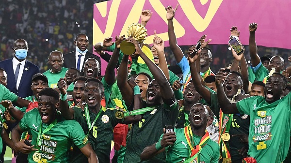 Senegal captain Kalidou Koulibaly hoists the trophy amidst jubilation by his teammates
