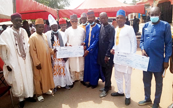  Mr Ben Abdallah Banda (4th from left), Coordinator of the Zongo Development Fund, and some representatives of the bereaved families with their dummy cheques