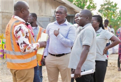 Dr Alex Asmah  (middle), CEO of Amenfiman Rural Bank, interacting with Dr Isaac Dasmani (left), Chief Executive of Prestea Huni-Valley Municipal Assembly, after the presentation.