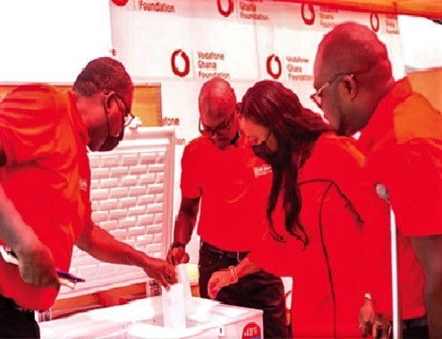 Rev. Amaris Nana Adjei Perbi (right), Head of Vodafone Foundation, Mrs Patricia Obo-Nai (2nd right), CEO, Vodafone Ghana, inspecting one of the equipment presented to the Ministry of Health