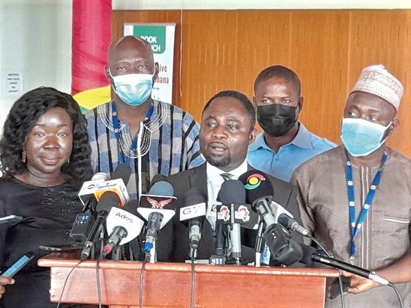 Mr Akandoh (middle), the Ranking Member on the Health Committee,  addressing the press