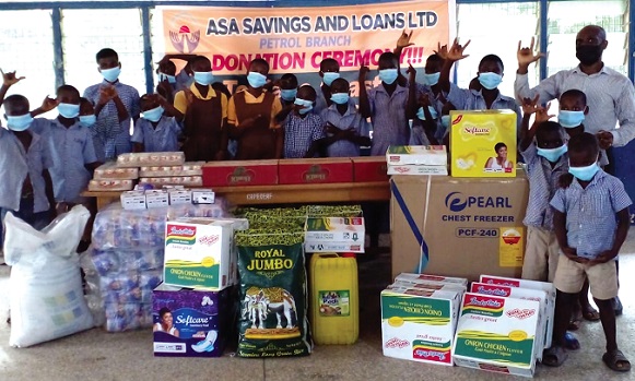 Beneficiaries of the Cape Coast School for the Deaf and Dumb with the items donated by Asa Savings and Loans Limited.
