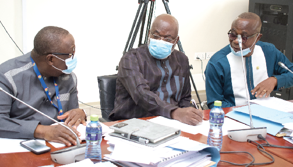 Dr James Klutse Avedzi (middle), Chairman of the Public Accounts Committee, having a discussion with Mr Samuel Atta-Mills (left),Vice Chairperson of the committee, and Mr Kofi Okyere Agyekum, Ranking Member of the PAC, at its sitting in Accra