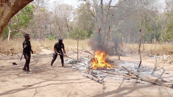 Police personnel destroying the hideout of the suspected criminals