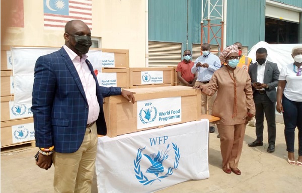 Ms Barbara Tulu Clemens (right), WFP Country Director, handing over the tent packages to Mr Seji Saji Amedunu (left), Deputy Director-General of NADMO