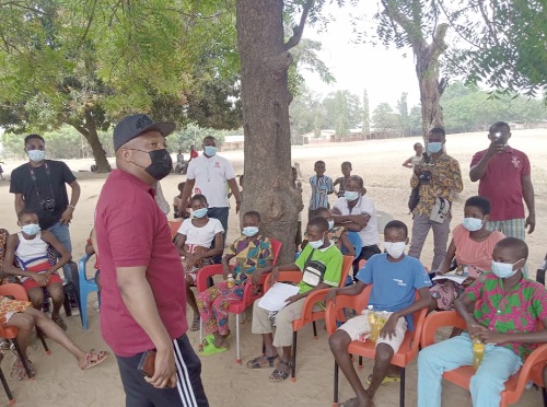 Mr Samuel Okudzeto Ablakwa (left) interacting with some adolescents at Vume. Picture: BENJAMIN XORNAM GLOVER