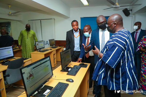 Mr James Boakye (2nd from right), Executive Director of the Leyden Educational Foundation, briefing Vice-President Dr Mahamudu Bawumia (right) during the inspection of the Integrated Online Centre at the University of Ghana after the launch