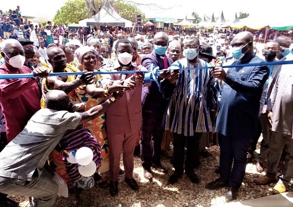 Rev. John Ntim Fordjour (middle), a Deputy Education Minister, being assisted by Mr Kelvin Kwaku Yeboah (right), Executive Director of the VALCO Trust Fund, and Dr Mohammed Amin Adam (2nd from right), a Deputy Minister of Energy, to perform the symbolic inauguration of the new school blocks