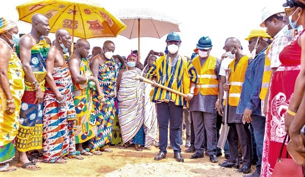 Rev. John Ntim Fordjour (in smock) performing the ground breaking ceremony at Abenase